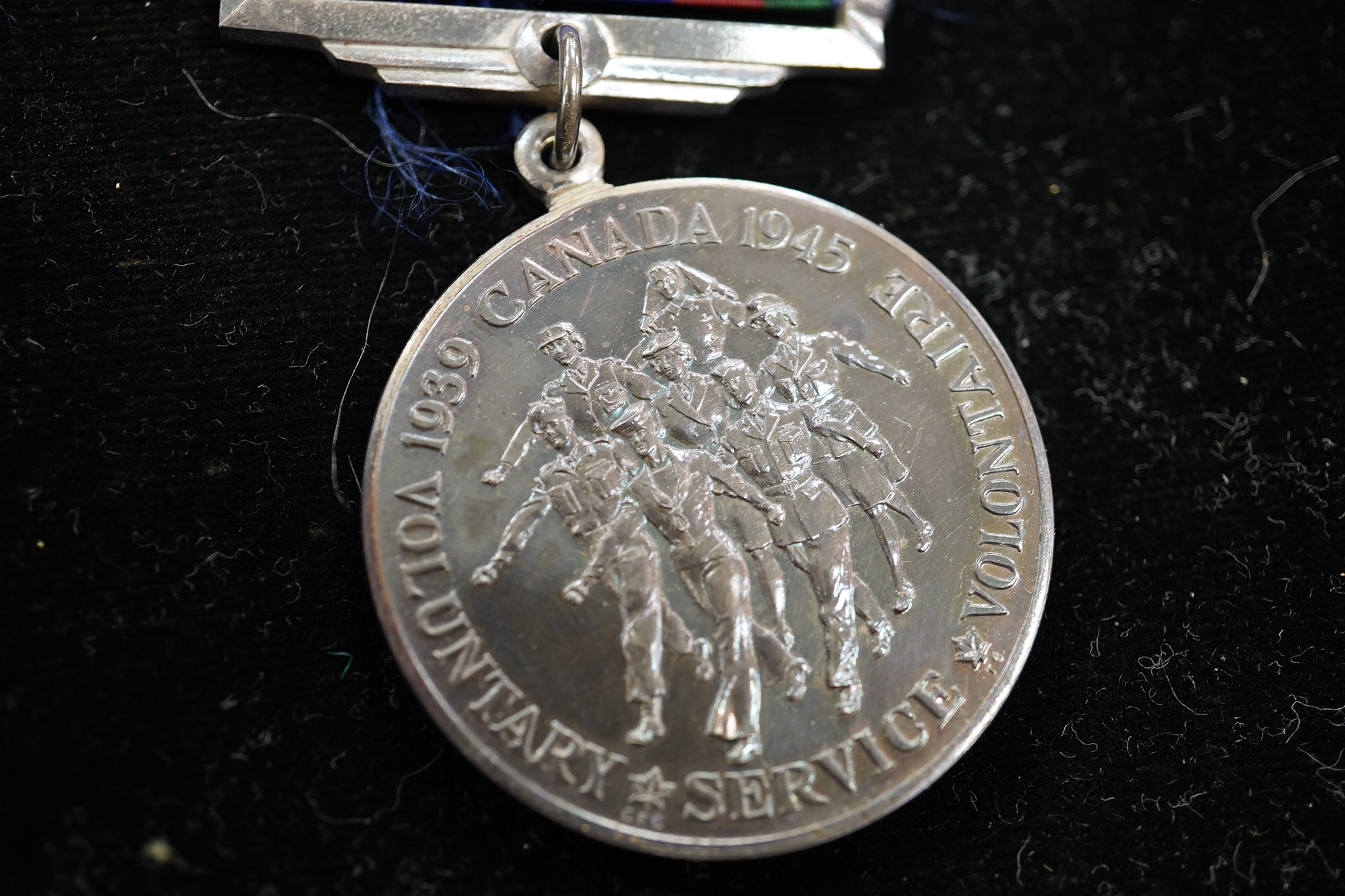 A group of five framed medals including the 1939 to 1945 Canada voluntary service medal, awarded to Private R.E. Bent, 48 Highlanders. Condition - fair to good